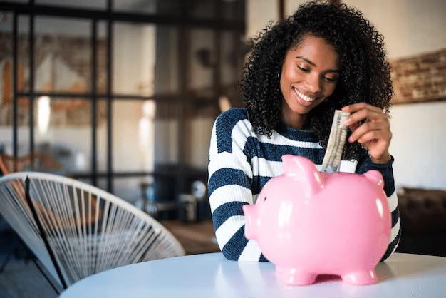 a lady keeping her money inside the piggy bank