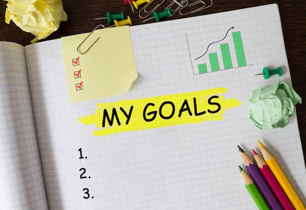 A book and markers with "my Goals" written on paper 